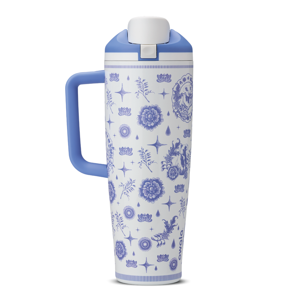 Heirloom 40oz Tumbler with handle; white body with blue delft-style illustrated pattern of stars, flowers, and charms; periwinkle blue handle and lid