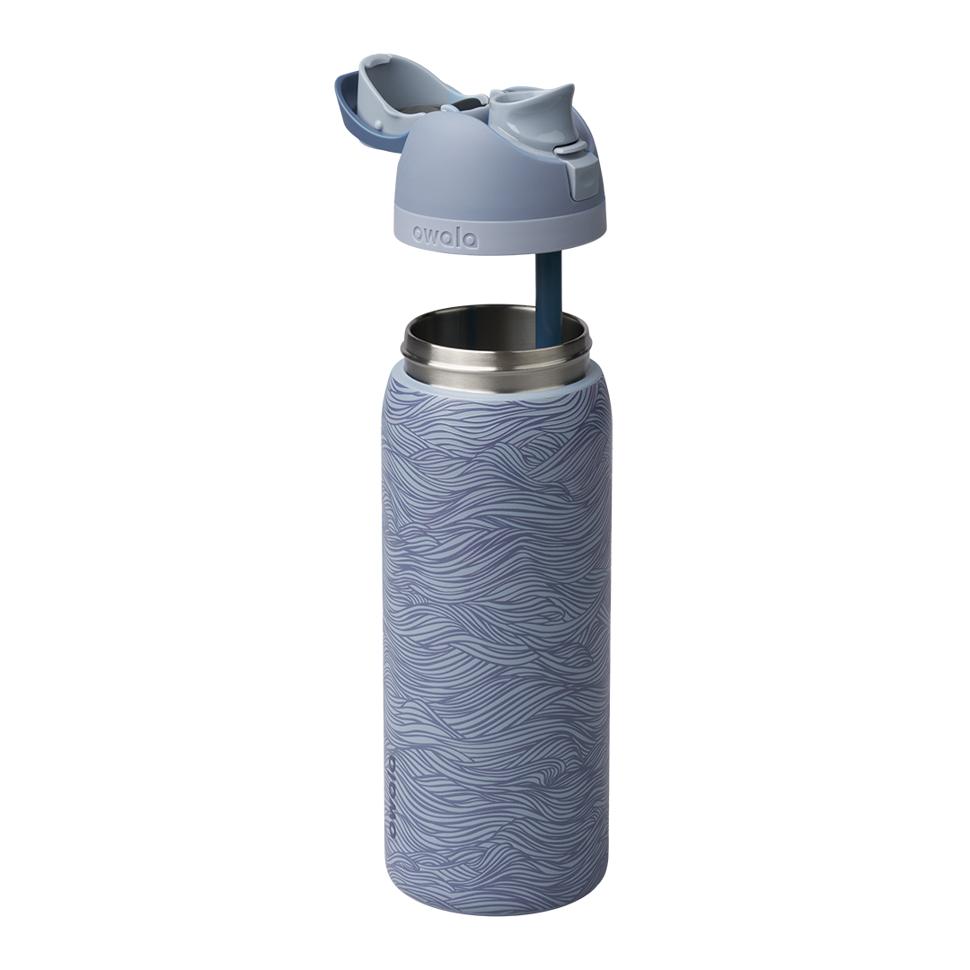Owala FreeSip 32oz exploded view, slate blue body with wave texture shown with lid lifted off revealing the silicone straw and stainless steel interior