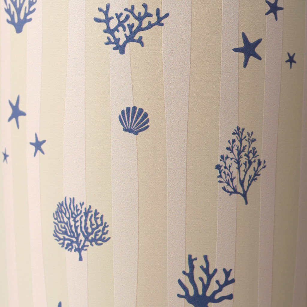 Owala FreeSip Tumbler 30oz in Coral Cabana, close-up of cream body with vertical stripes and navy coral, starfish, and seashell illustrations