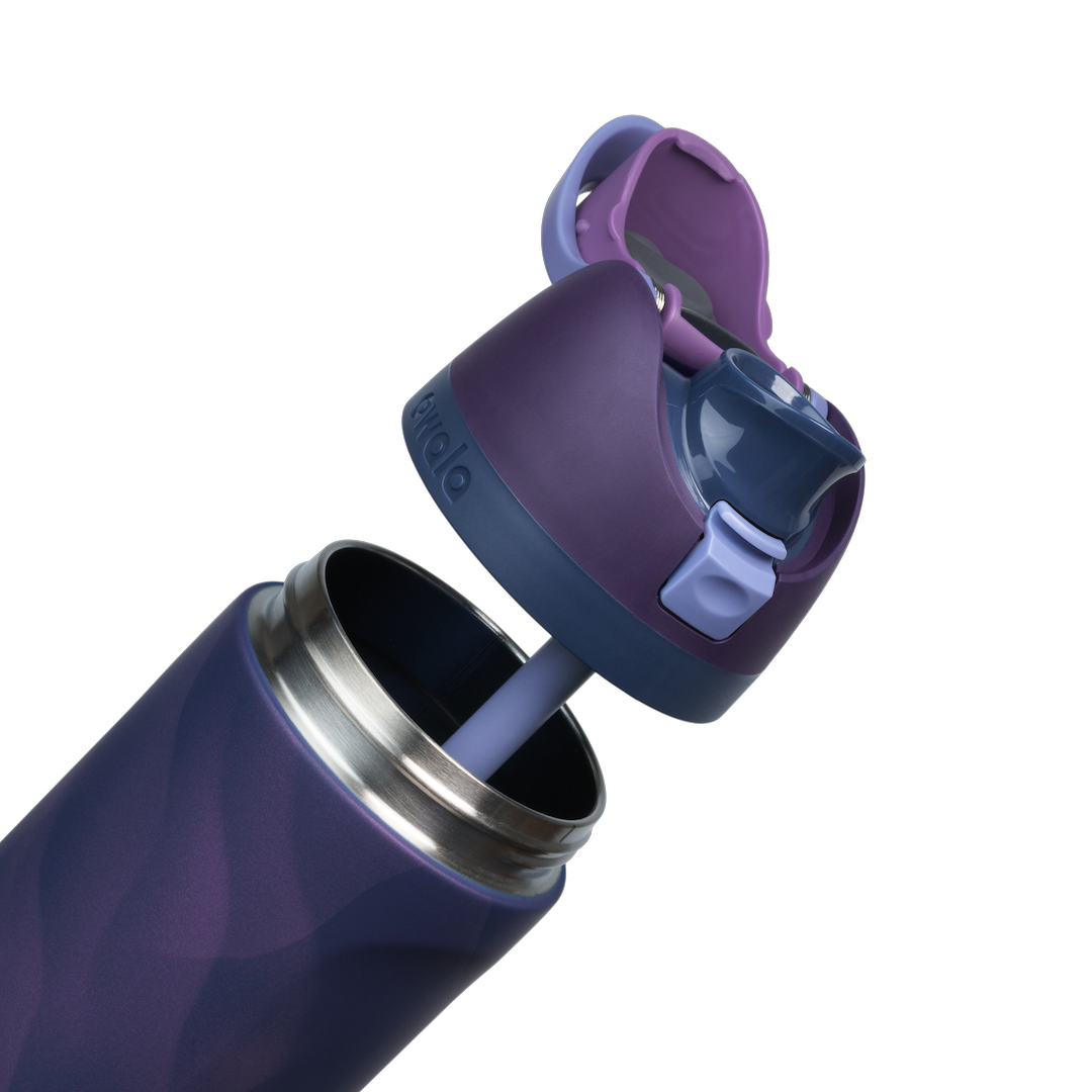 Owala FreeSip 24oz in Arctic Storm, exploded view showing the deep purple body, navy lid with periwinkle carry loop, deep purple flip cap with periwinkle FreeSip spout, and lavender silicone straw