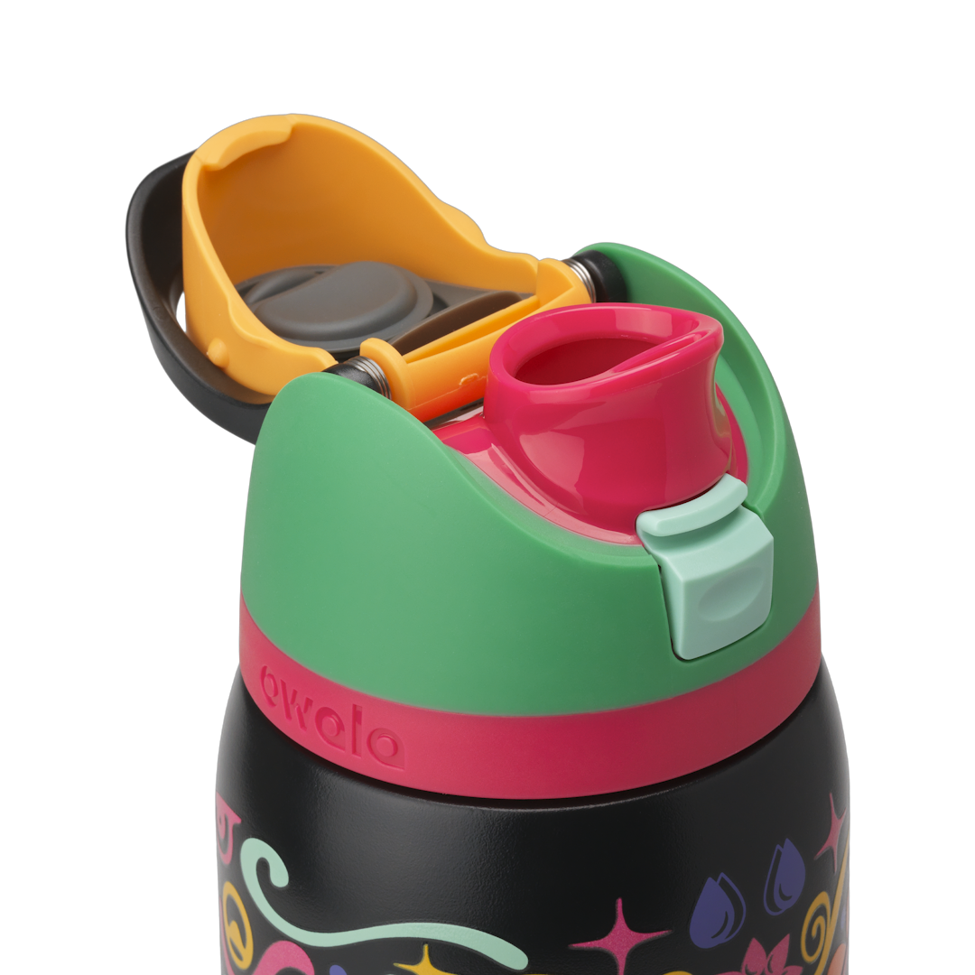 Owala FreeSip Sway 32oz in Sugar Skull, green flip cap open exposing pink FreeSip spout with mint green push-button over sugar-skull patterned body; glows in the dark